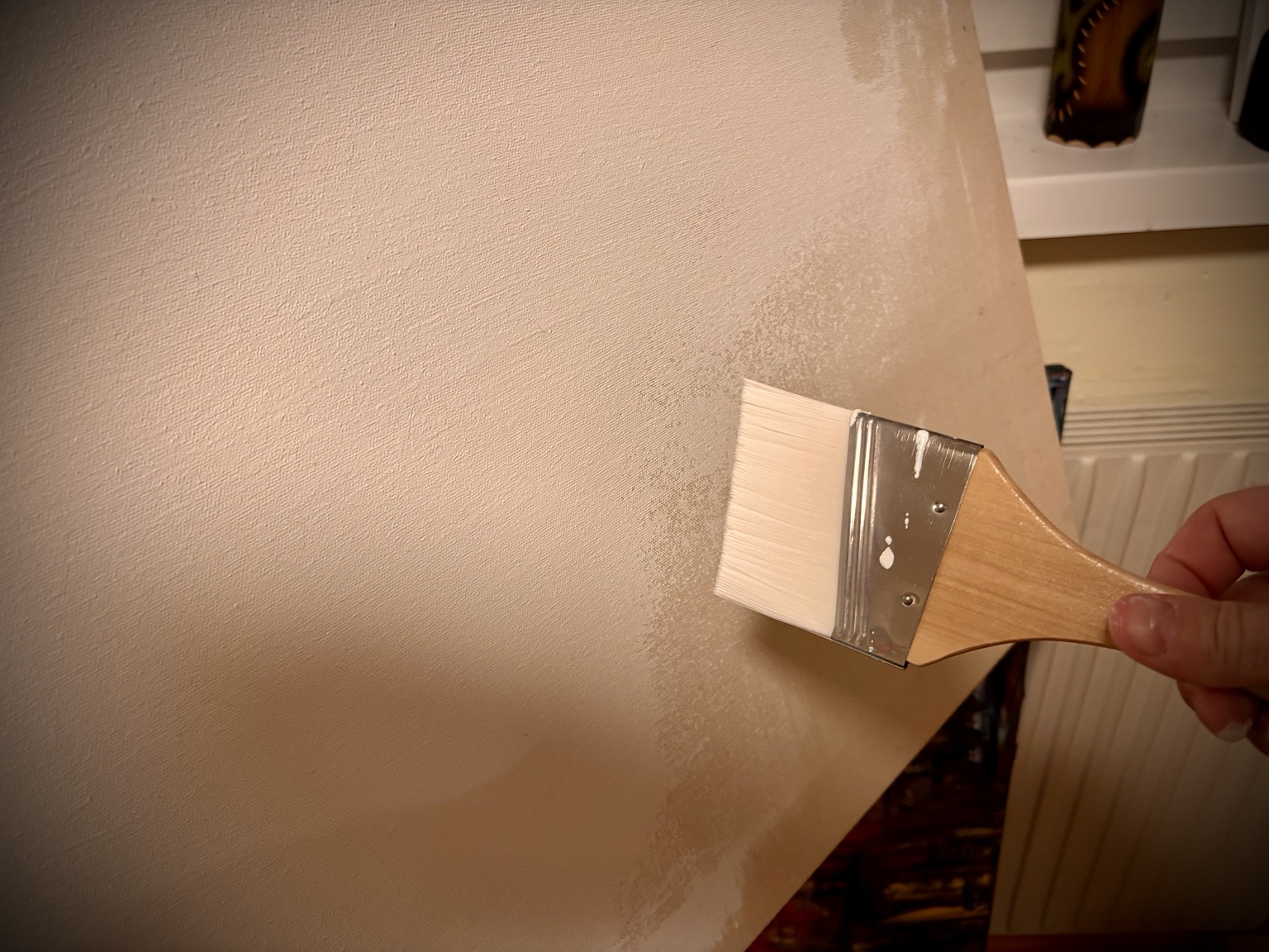 Brush coating the surface of a canvas