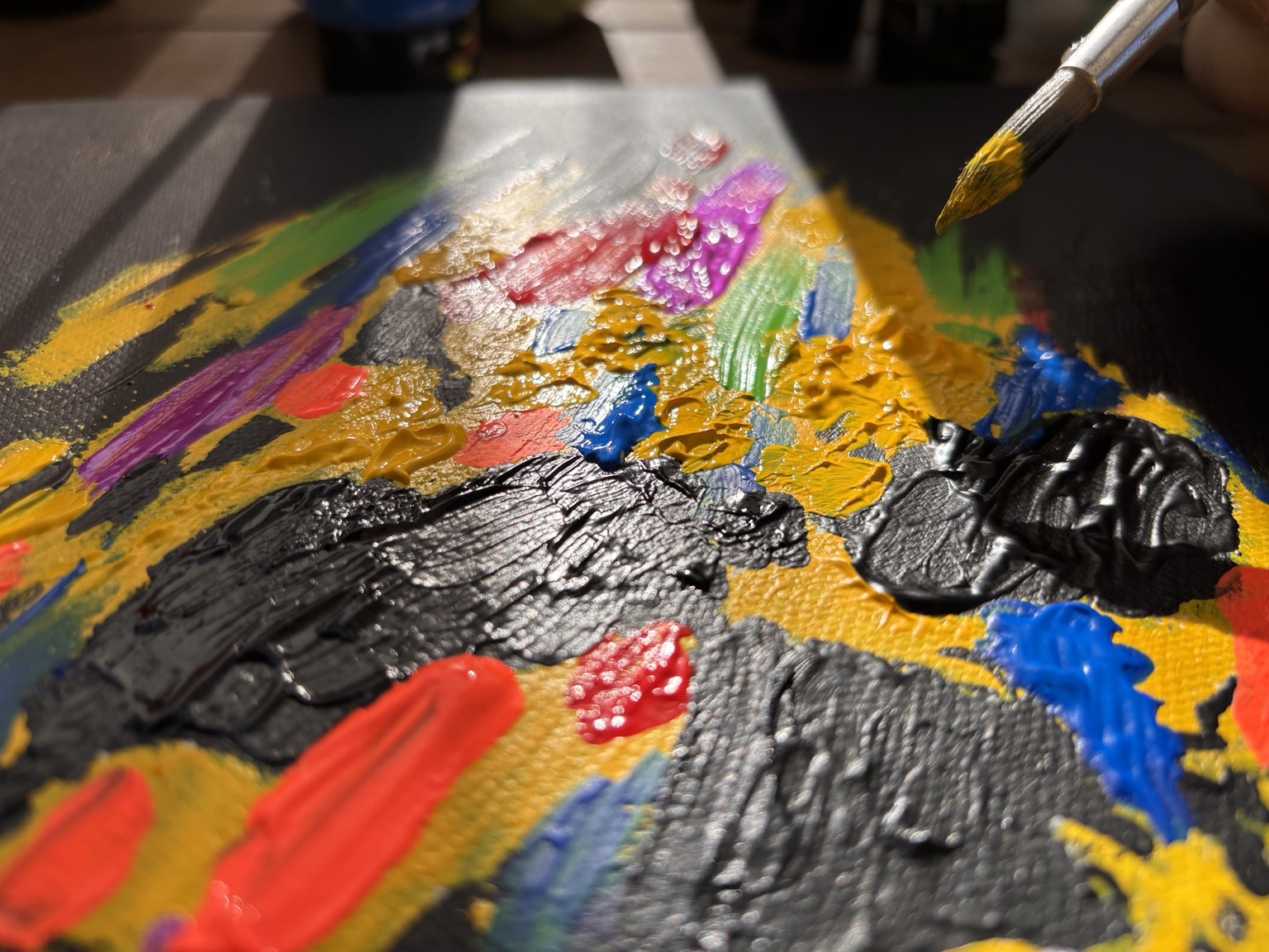 Thick paint being worked into the canvas
